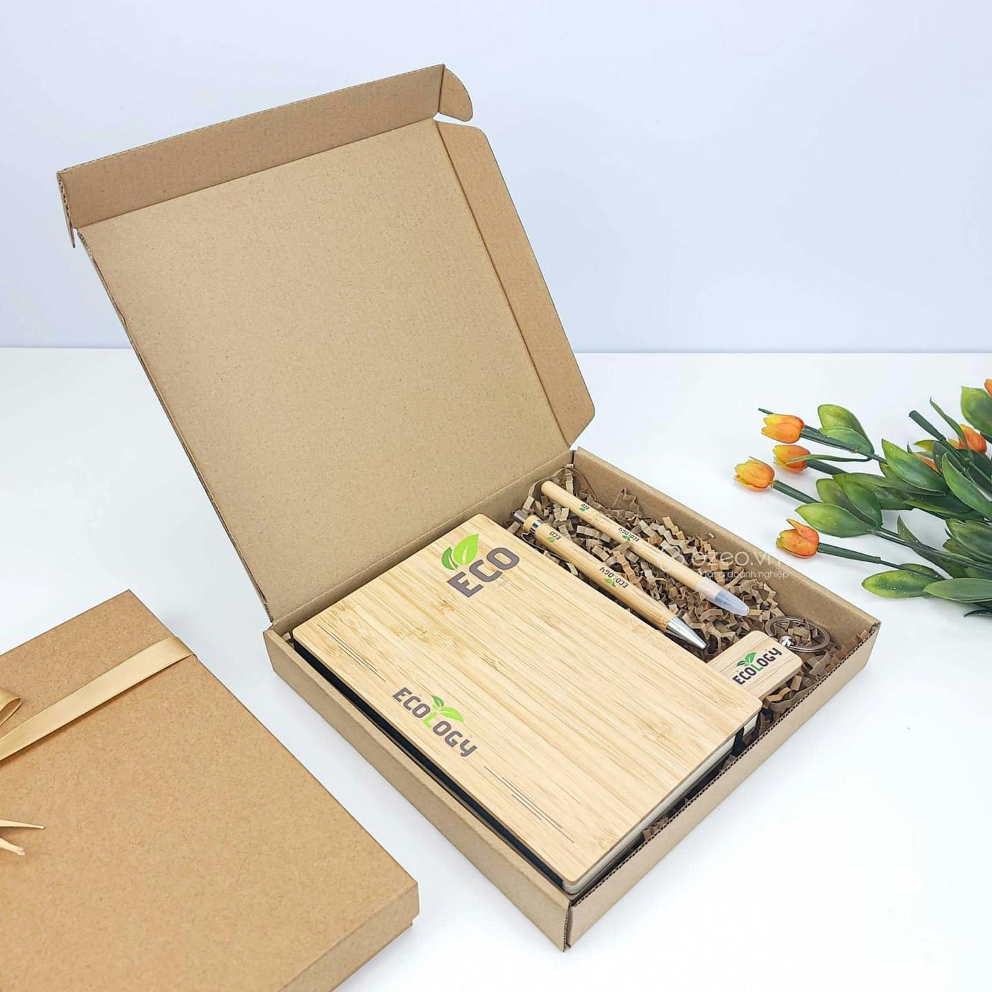Eco-friendly office supplies in an open cardboard box.